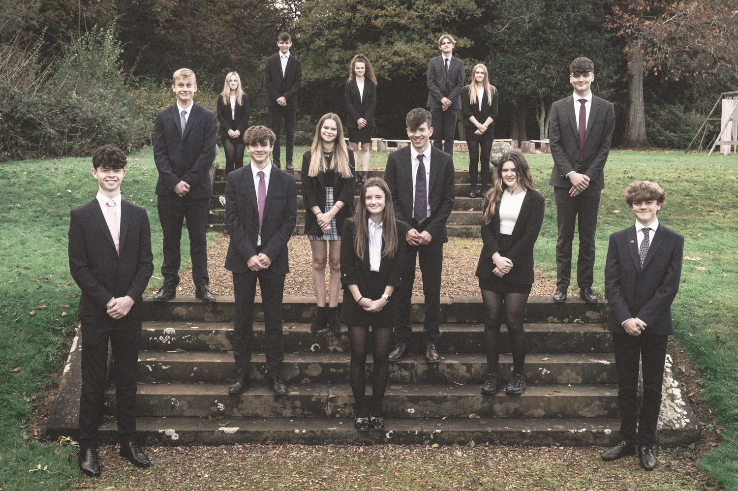 Young enterprise students standing on steps